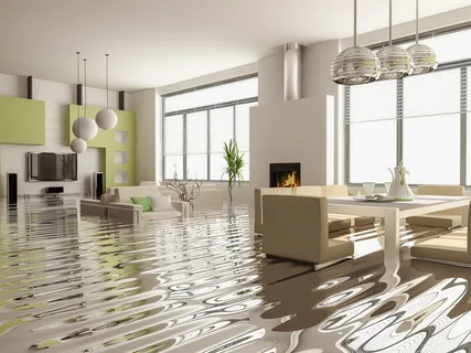 water damage cleanup technicians removing standing water from hardwood floor after pipe burst