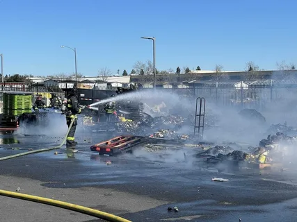 Firefighters extinguishing remaining flames and smoke at a fire-damaged property before fire damage restoration in Edmond
